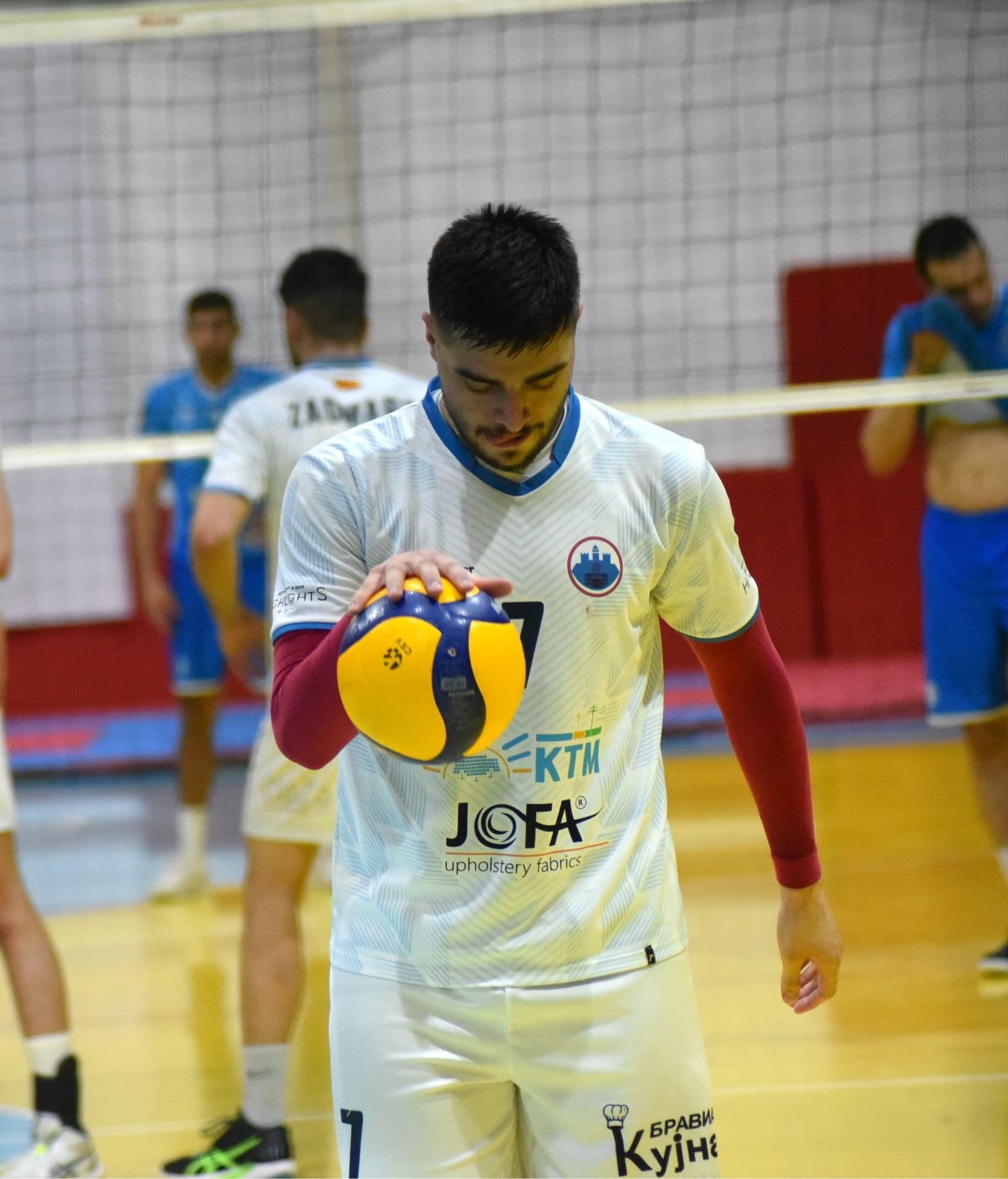 Player holding the ball before a serve